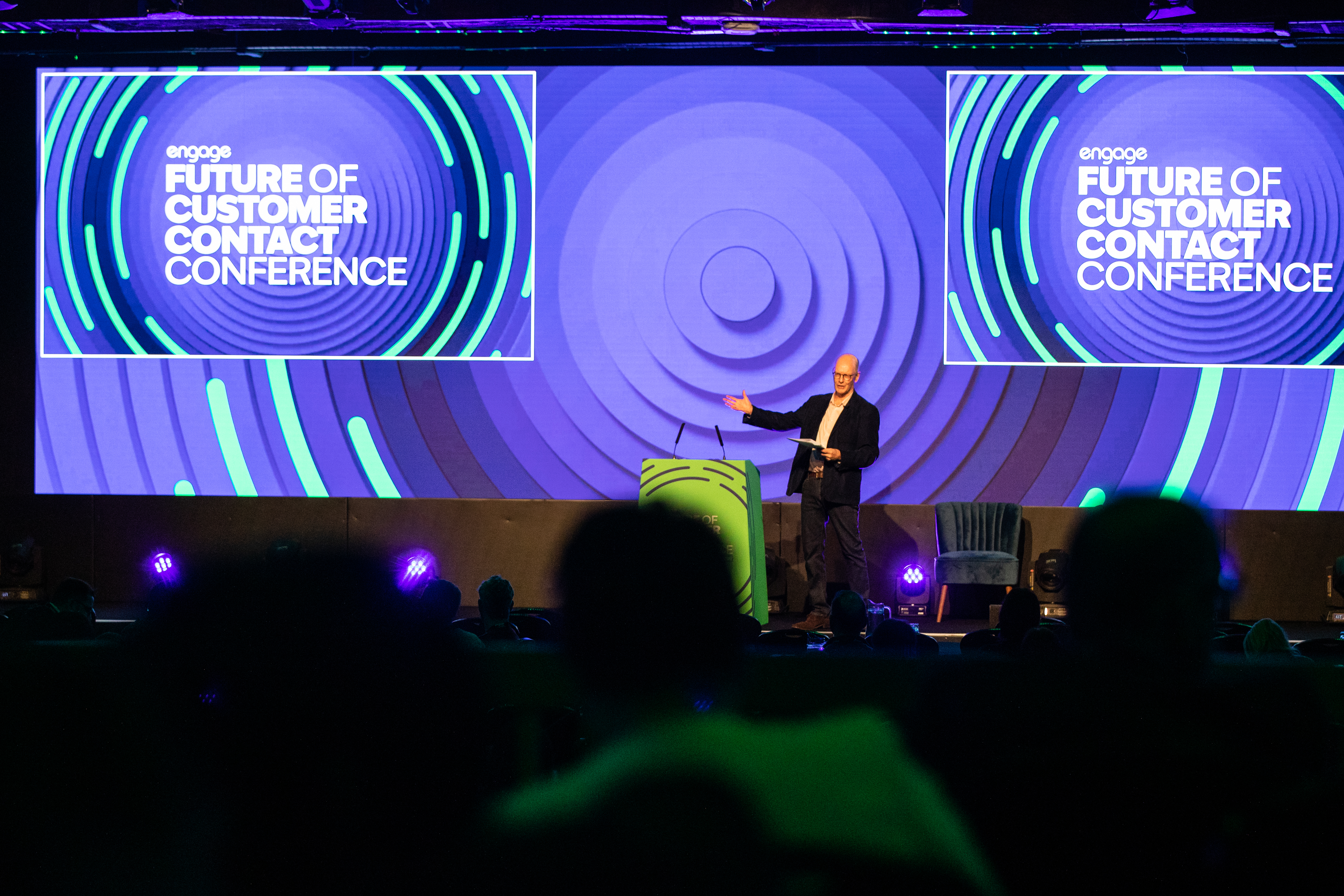 A man on stage at a conference